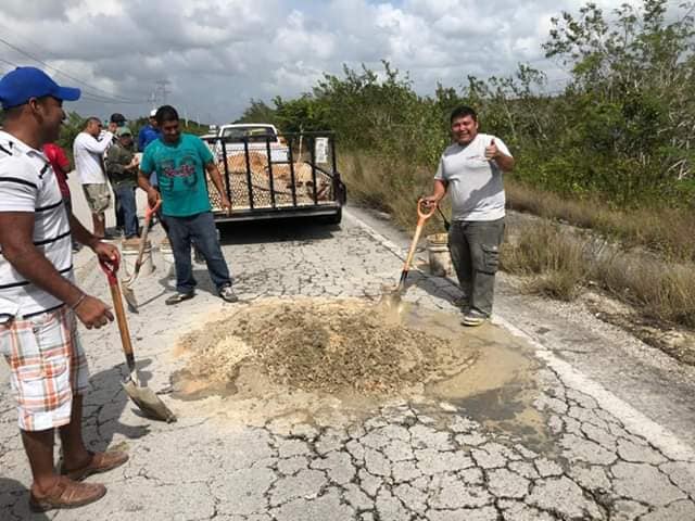 Mahahual residents covering potholes